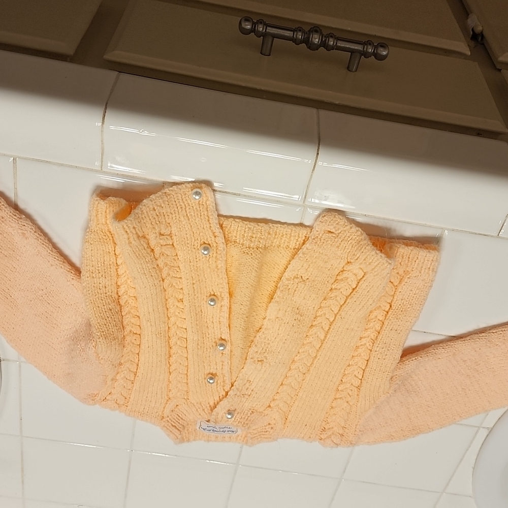 Handmade baby sweater with pearl buttons